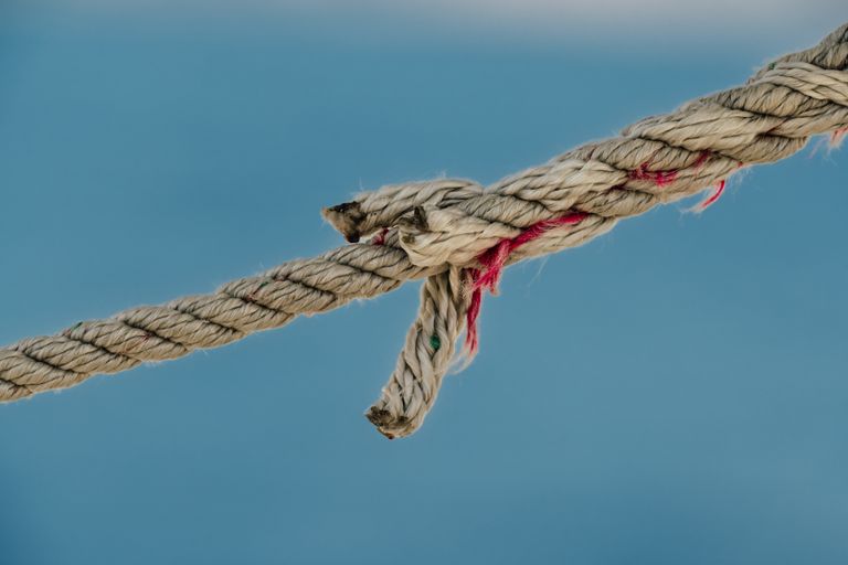A rope continuing to carry its load after one of its first strands has begun to fail.